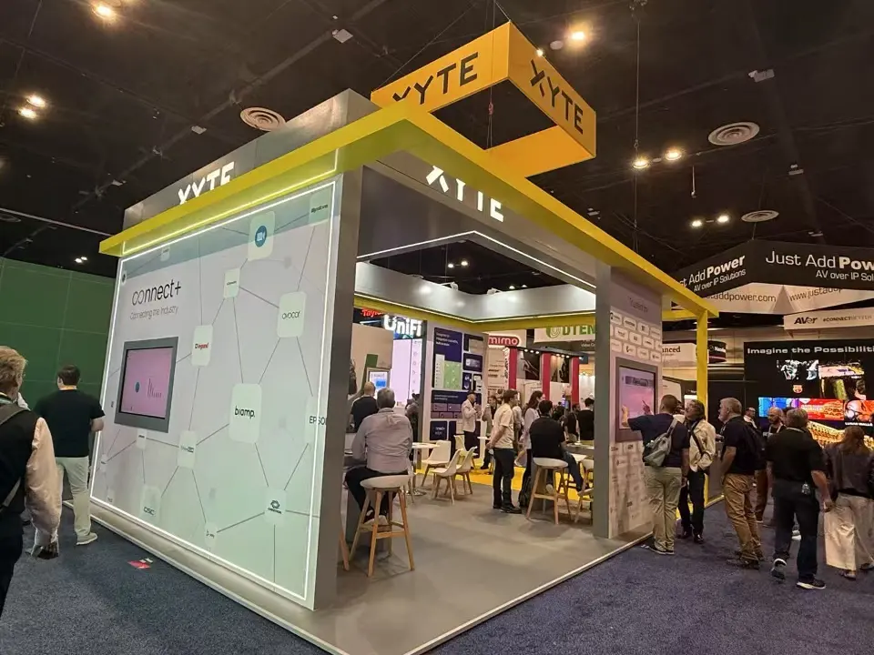Backlit Connect+ wall with partner logo network and inset screen on the XYTE stand