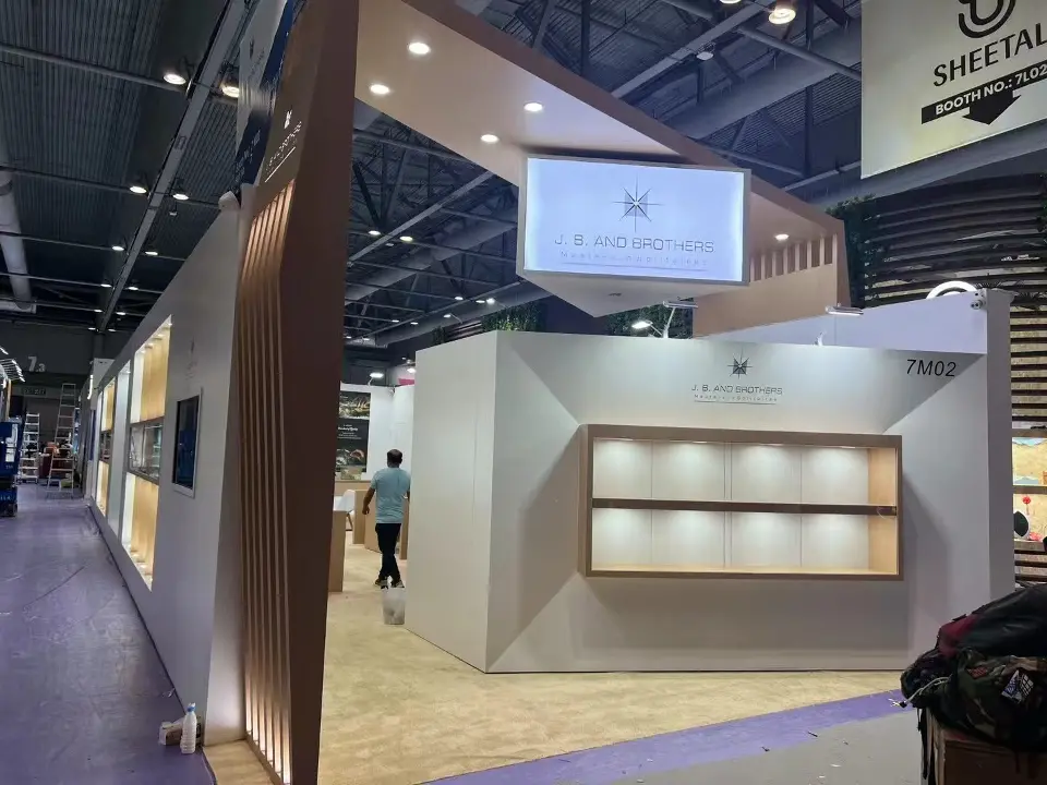 J.B. and Brothers stand front with angled white facade, lit wood-framed niche and hanging lightbox