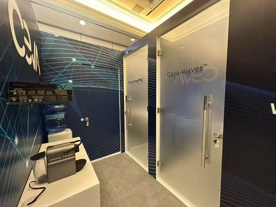Frosted glass doors marked Ceva-NeuPro and Ceva-Waves beside a coffee and water station