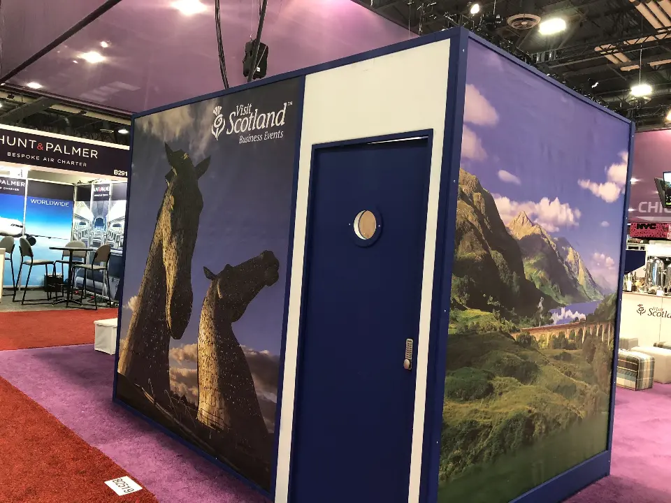 Navy-framed meeting cube wrapped in Scottish landscape and stag graphics