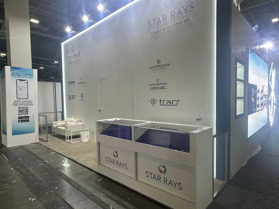 Lit graphic wall, lounge chair behind glass rail and showcase counter