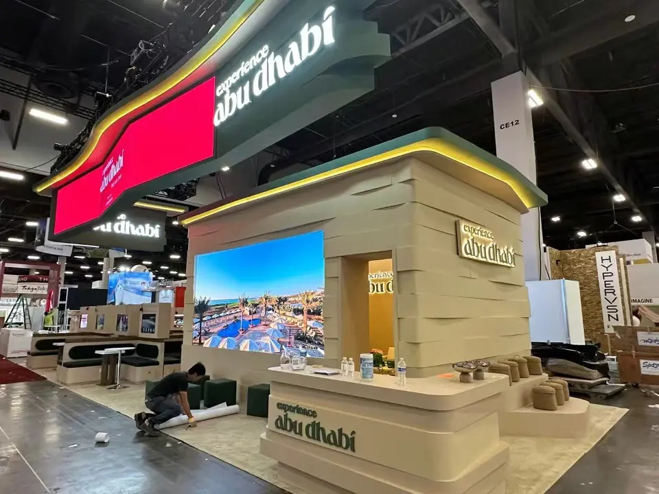 Abu Dhabi counter in wood-look finish beside a large video screen