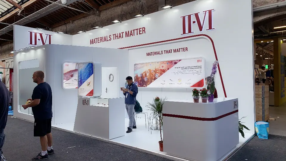 Front view with a small group gathered beside the plant and reception counter