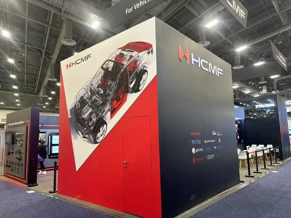 Rear corner of the HCMF stand with a large red car cutaway graphic and HCMF logo