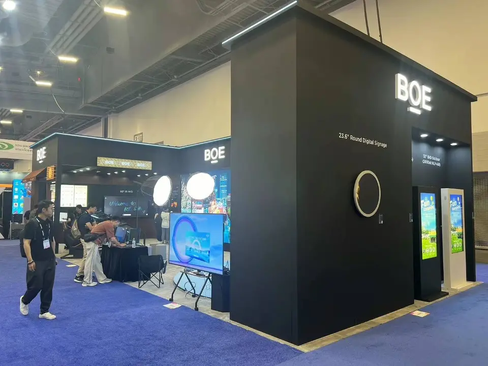 Tall black BOE tower with round light feature and kiosk screens