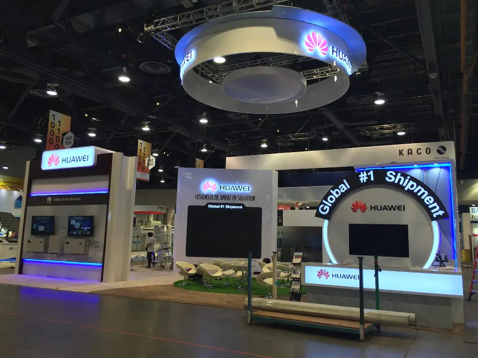 Front of the finished booth with blue lit base, white counter and display screen