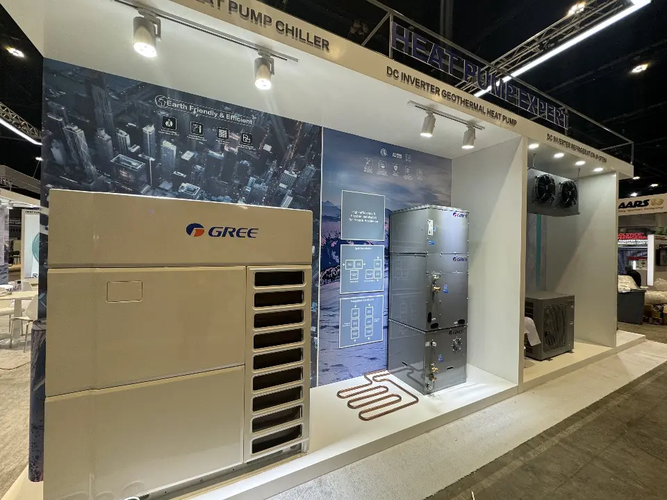Inverter heat pump chiller unit against a dark textured graphic wall