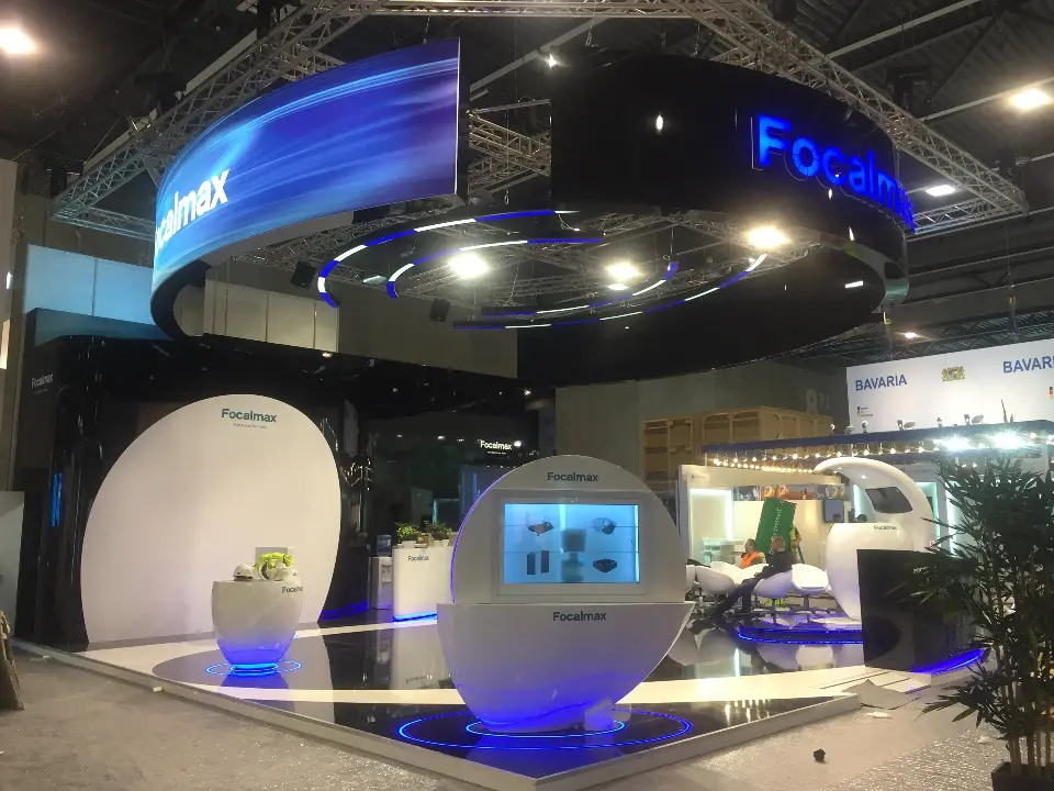 Wide finished view of the ring header, white pods and screen kiosks before opening