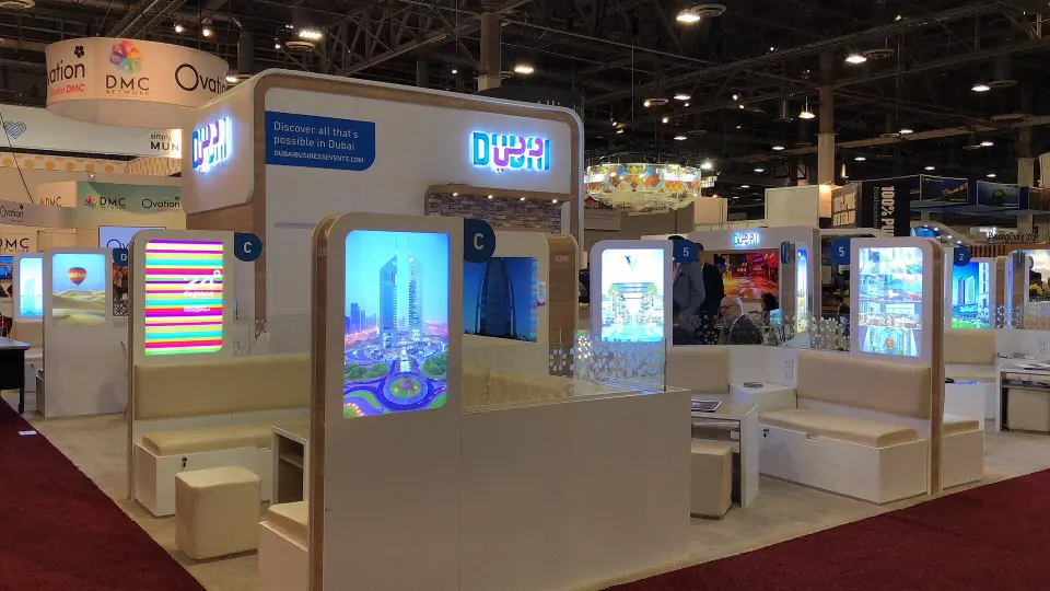 Aisle view of tall blue lightboxes and lounge cubes