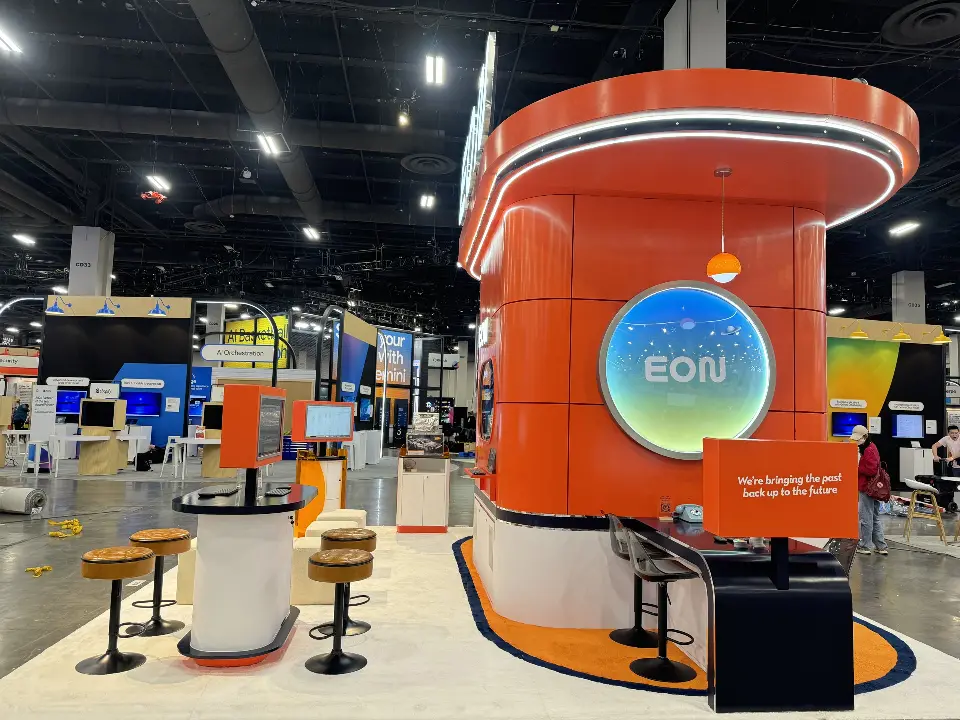 Orange EON tower with a round screen and bar seating