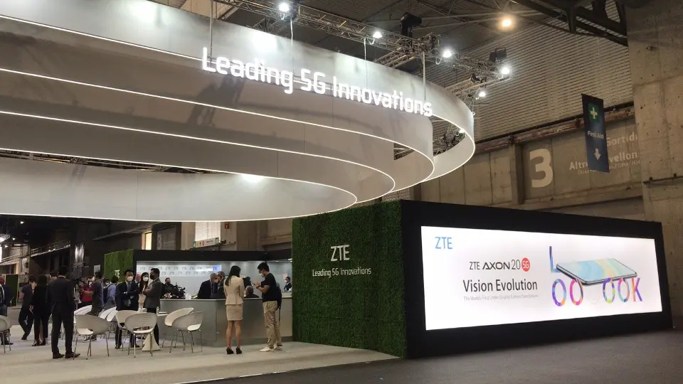 Canopy edge lettering above a seating area and large screen