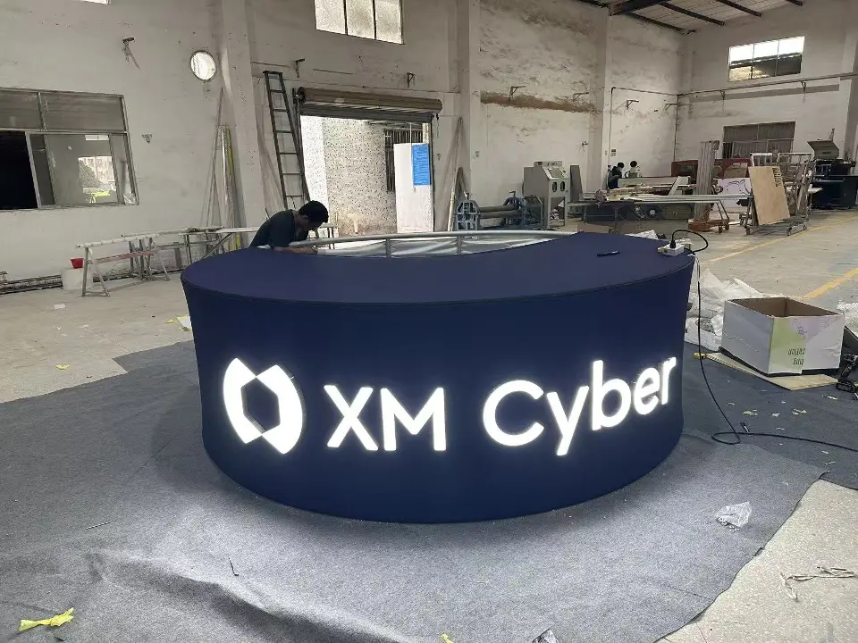 Close-up of the round XM Cyber counter with backlit lettering in the workshop
