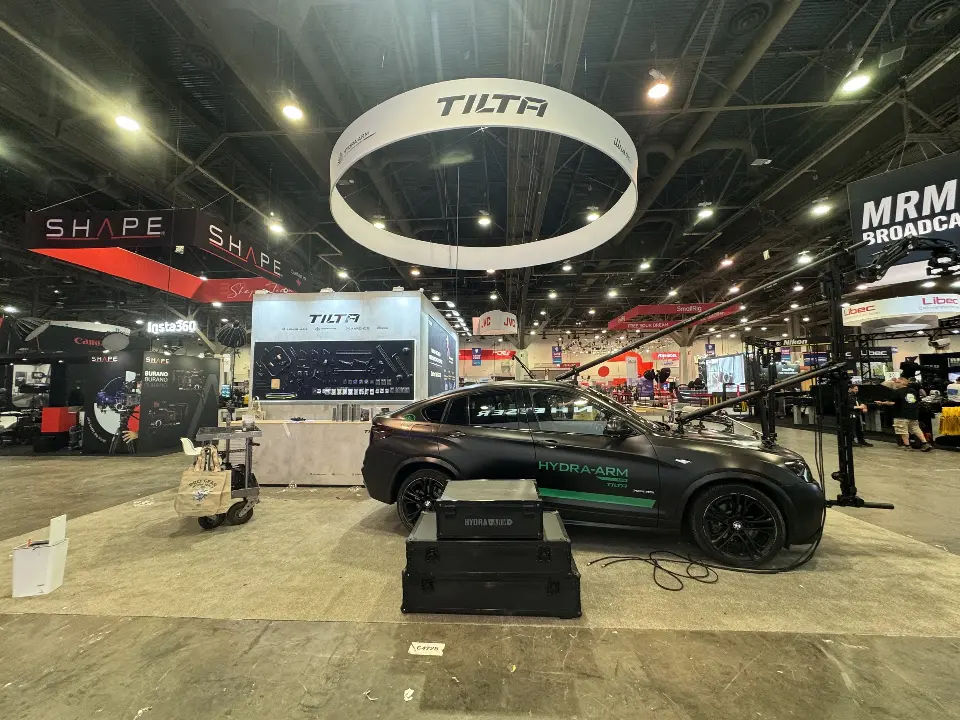 Side view of the SUV beside grey counters and the logo cube
