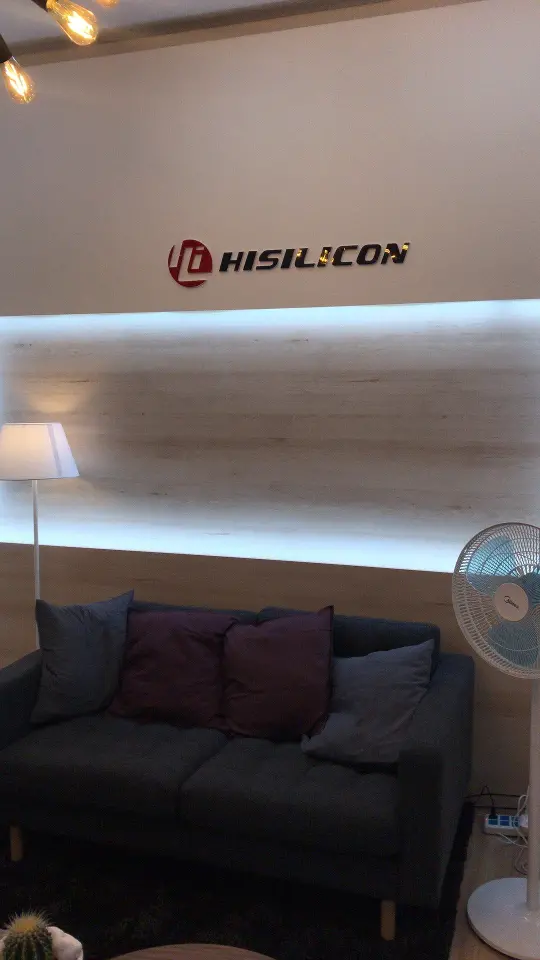 Lounge corner inside the booth with a dark sofa and cushions