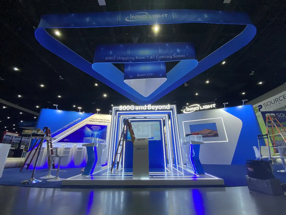 Front view of the InnoLight booth with triangular hanging frame and lit 800G and Beyond portal