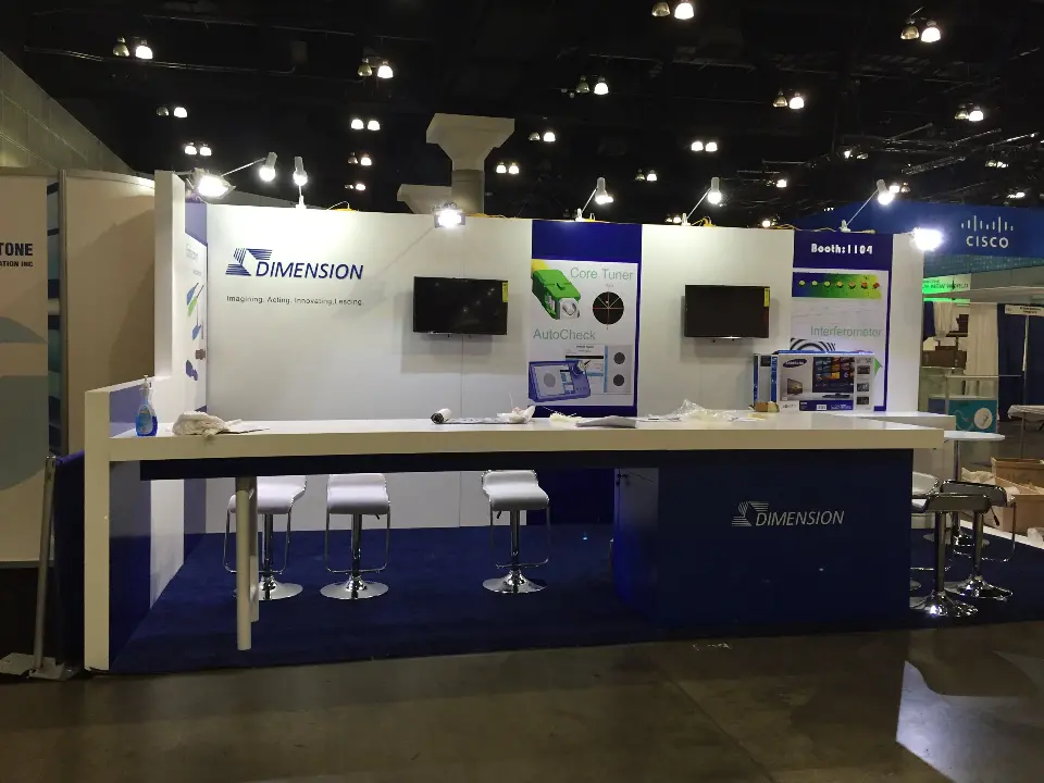 Dimension booth front with long white bar counter, stools and wall screens