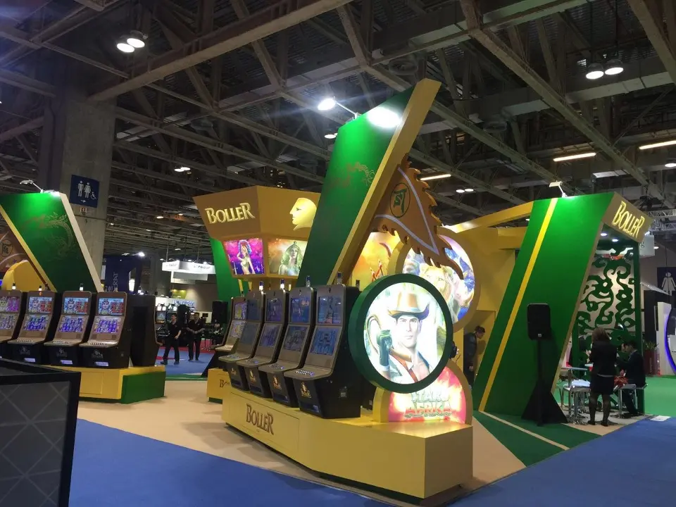 Angled view of slot machines and the round emblem with visitors walking by