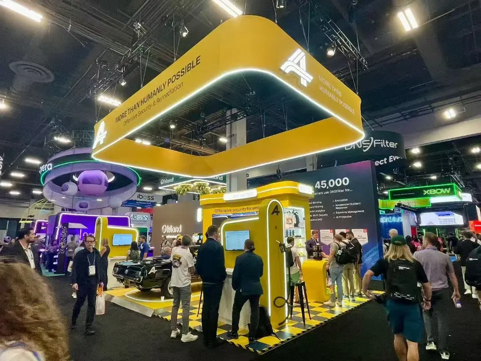 Advantage booth from a low corner angle, with the hanging frame and crowds in the aisle
