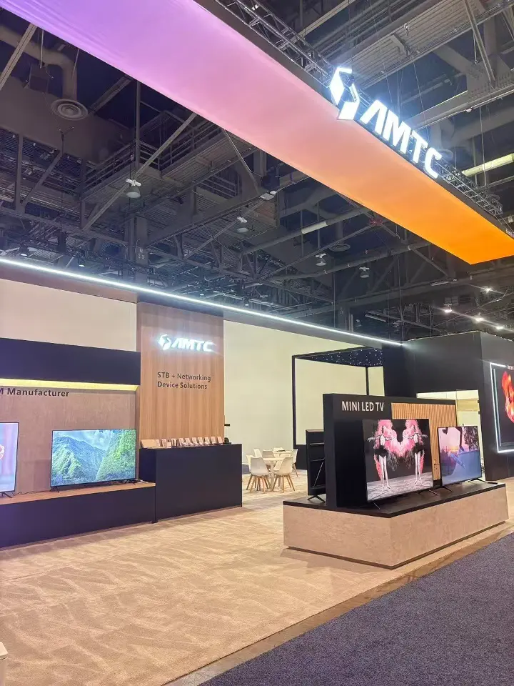 Portrait view inside the stand showing a wood-look wall, screens and a white counter