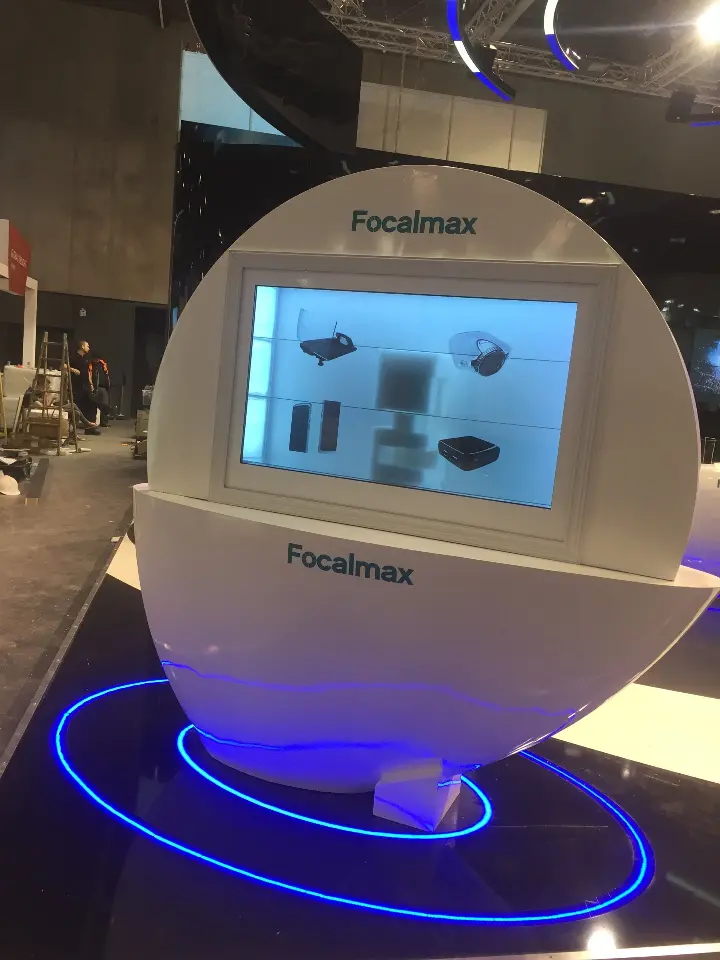 Close portrait of a white egg kiosk with built-in screen and a blue ring of light