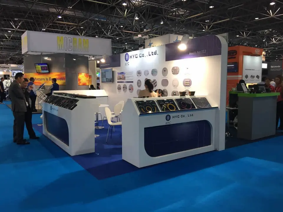 Side angle of the curved counters with product trays and a white display wall