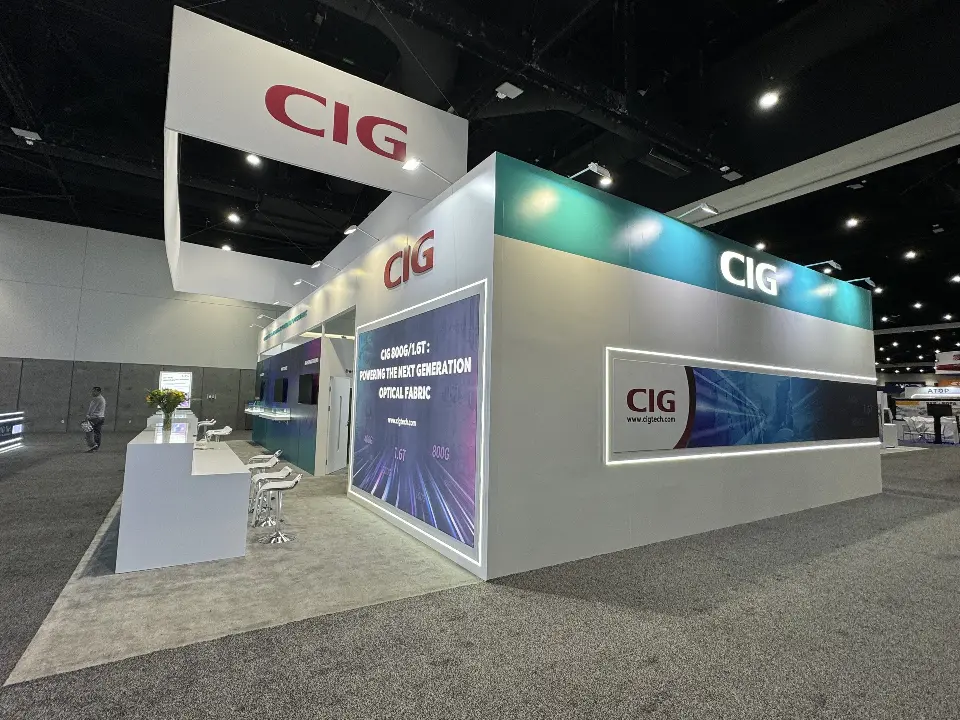 CIG booth corner with teal walls, white header and graphic panel framed by light