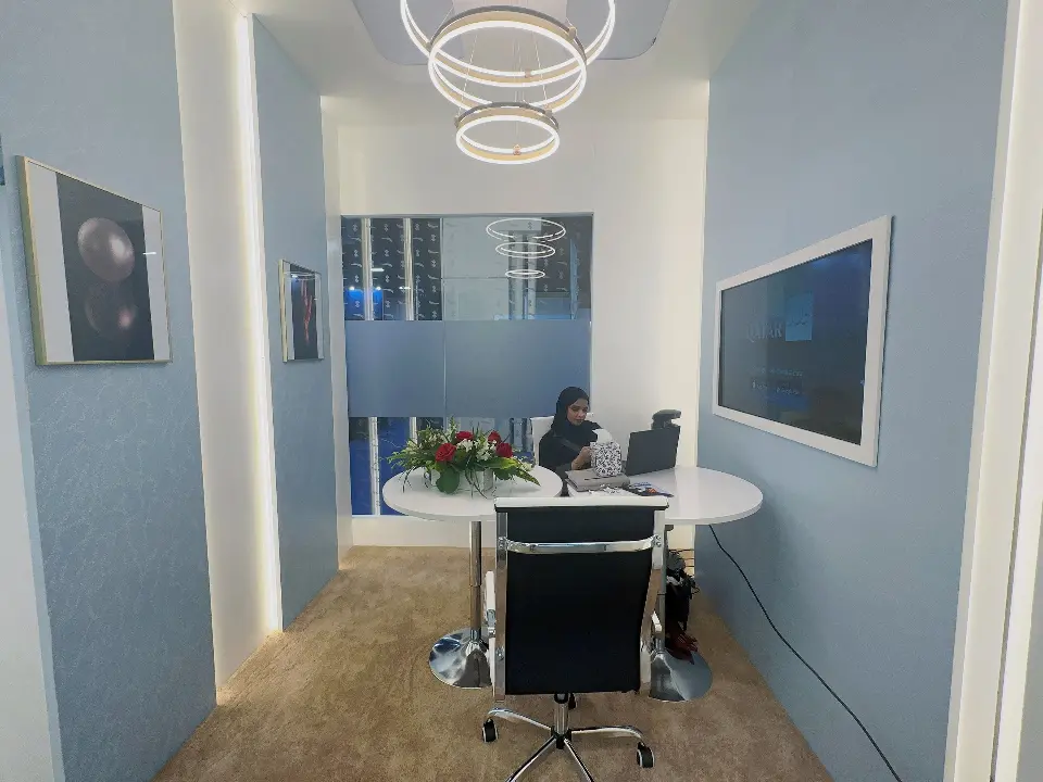 Meeting room with round table, office chair and ring pendant light
