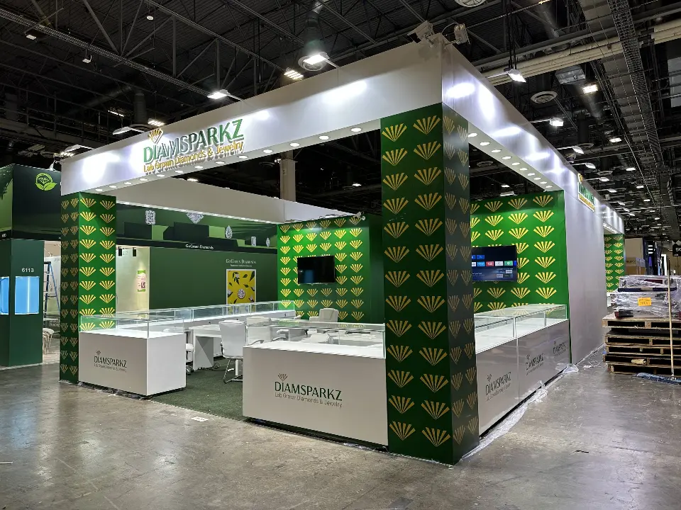 Front view of the Diamsparkz booth with white header and glass showcases