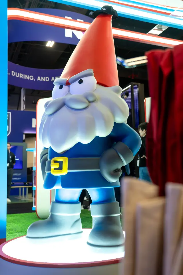 Portrait of the full gnome statue on its lit round base