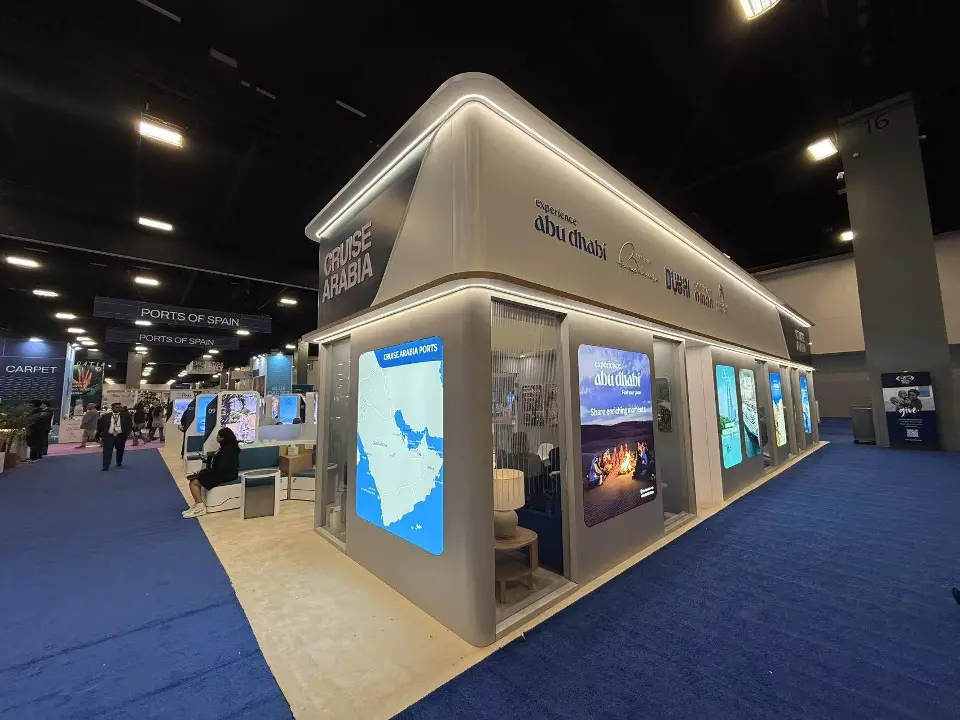 Angled view of the booth corner with tall backlit destination graphics