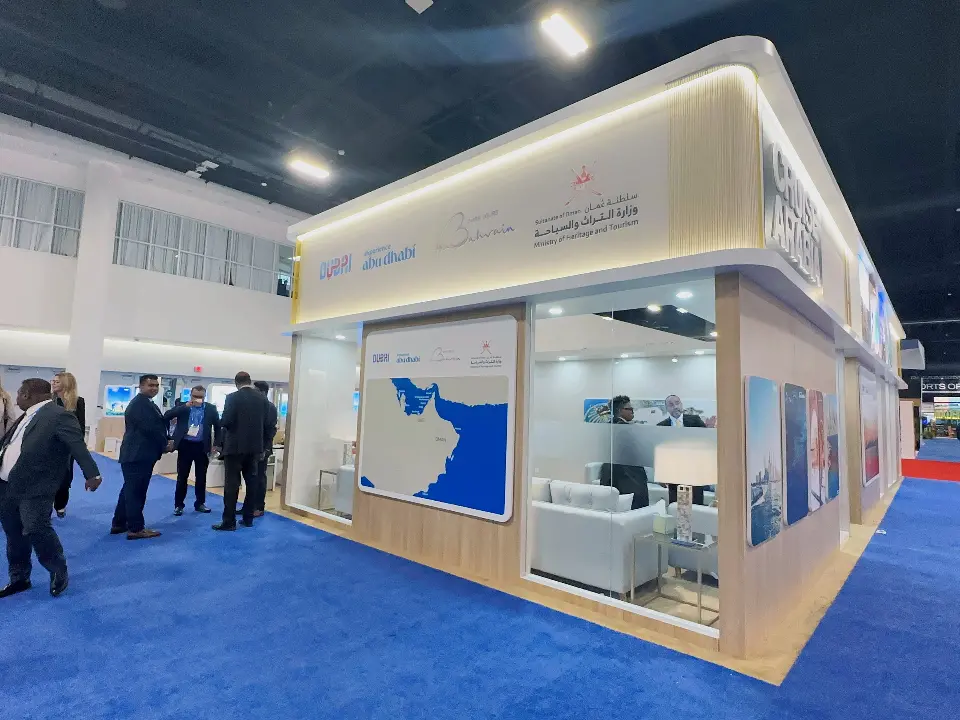 Glass meeting room with Dubai map graphic and white seating at the corner