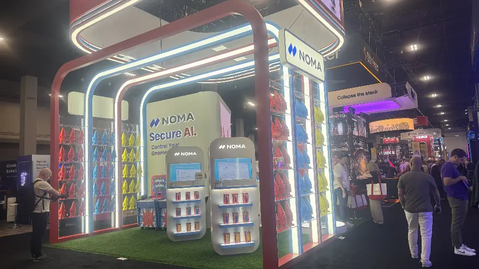 Side view of turf floor, lit arches and 'Secure AI' panel inside the booth