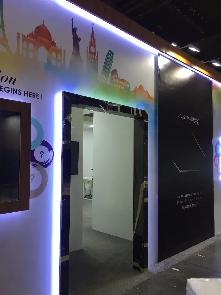 Portrait of a side doorway framed by light strips under the skyline graphic