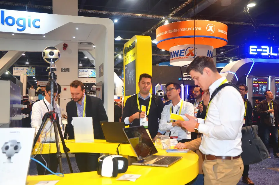 Busy view of the Insta360 counter with visitors handling cameras