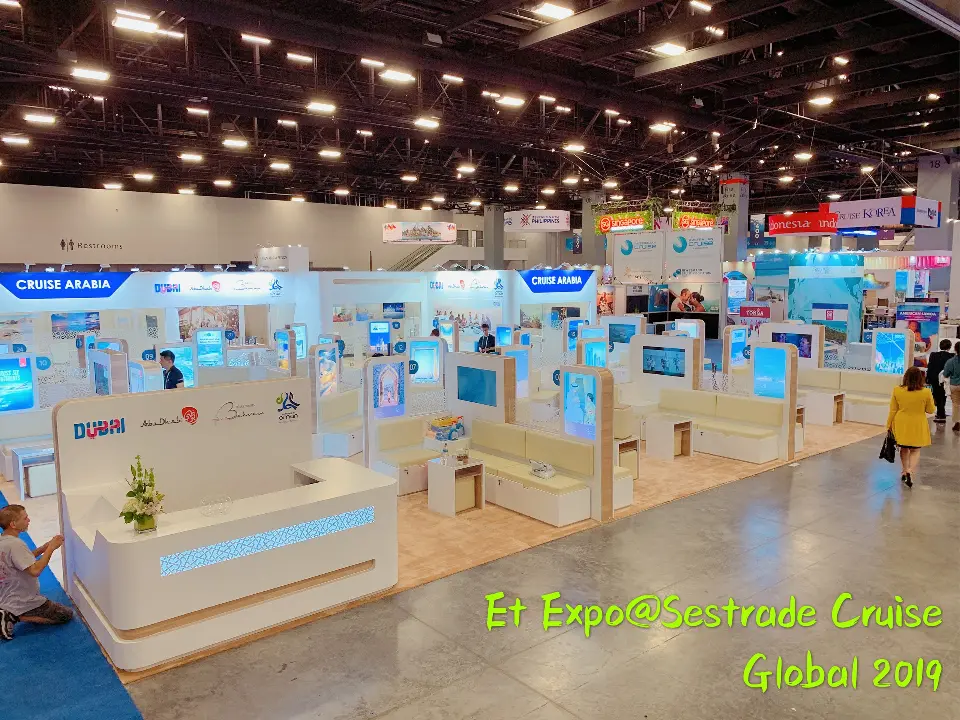 Wide view of the pods and lit panels across the booth floor