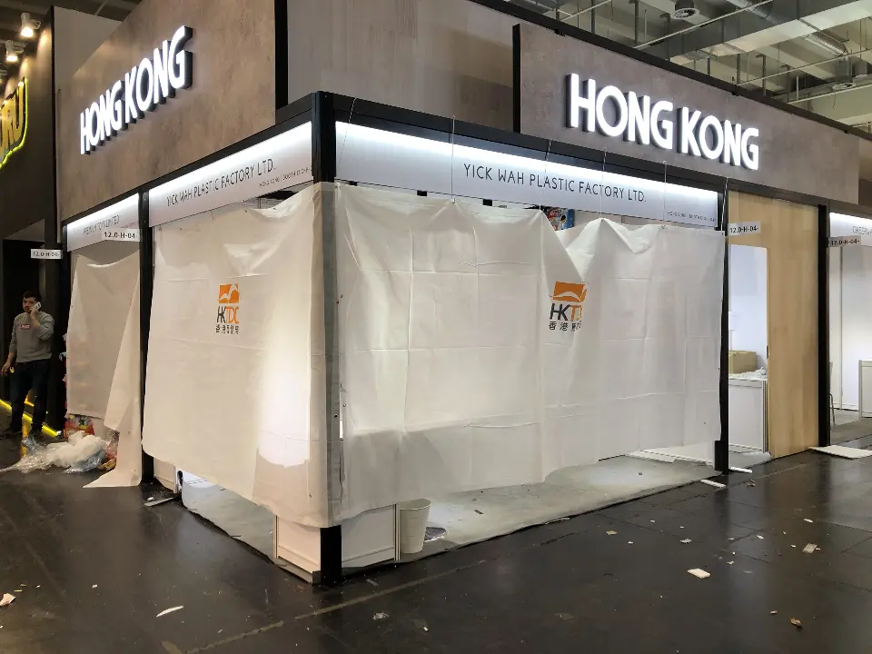 Covered white booth under a lit fascia carrying the HONG KONG sign