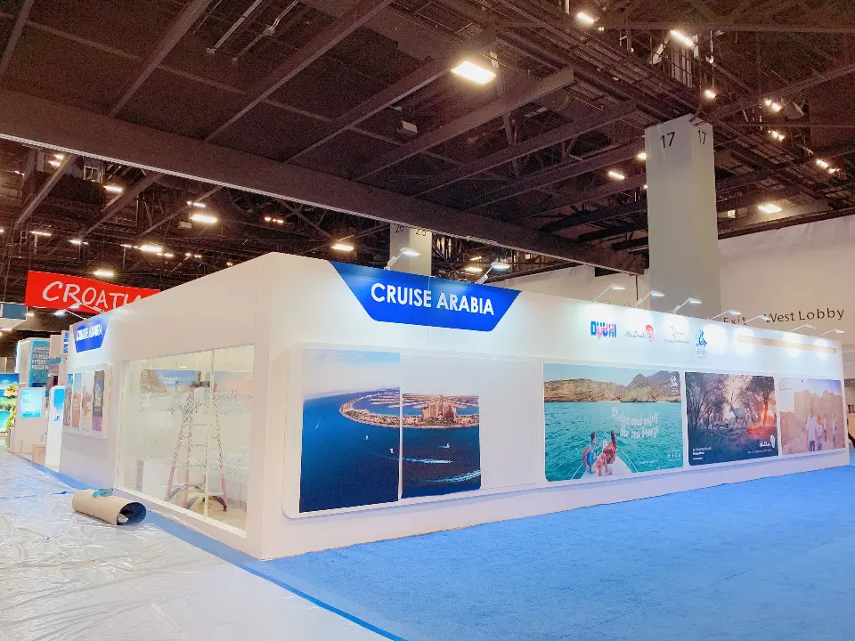 Exterior wall with a blue CRUISE ARABIA header and destination photo graphics