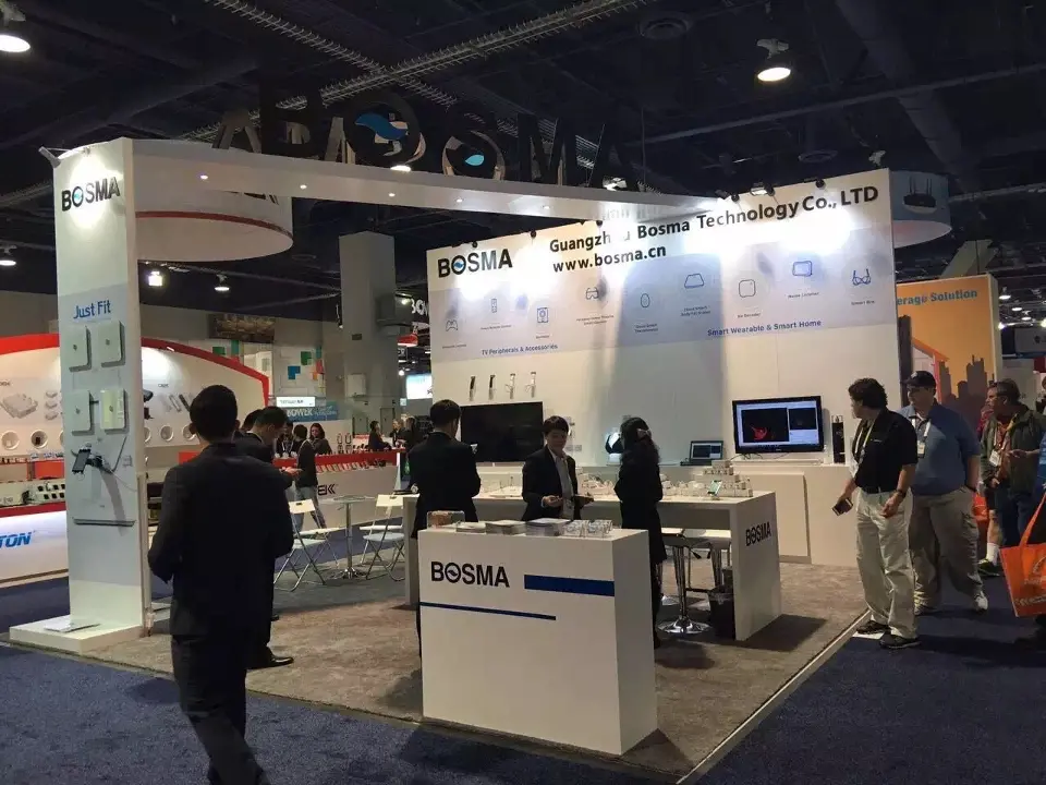 Visitors around the blue-trim BOSMA counter and video screen in the open booth