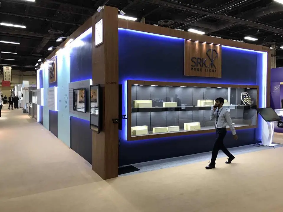 Wide corner of the navy side with showcases and walnut-look frame