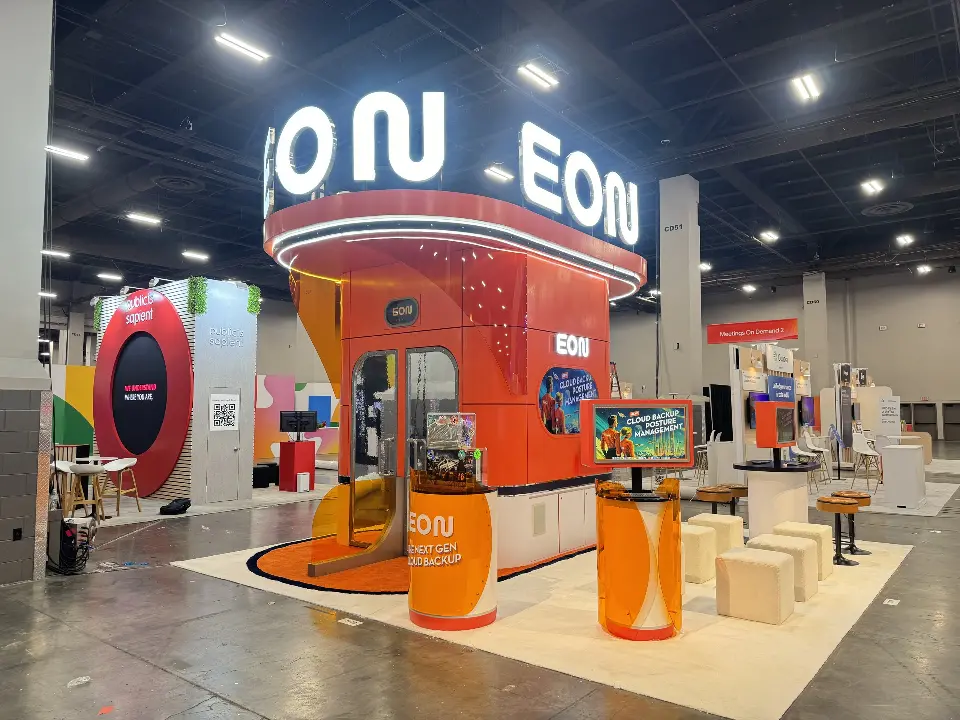 Wide view of the EON booth with cube seats and orange tower