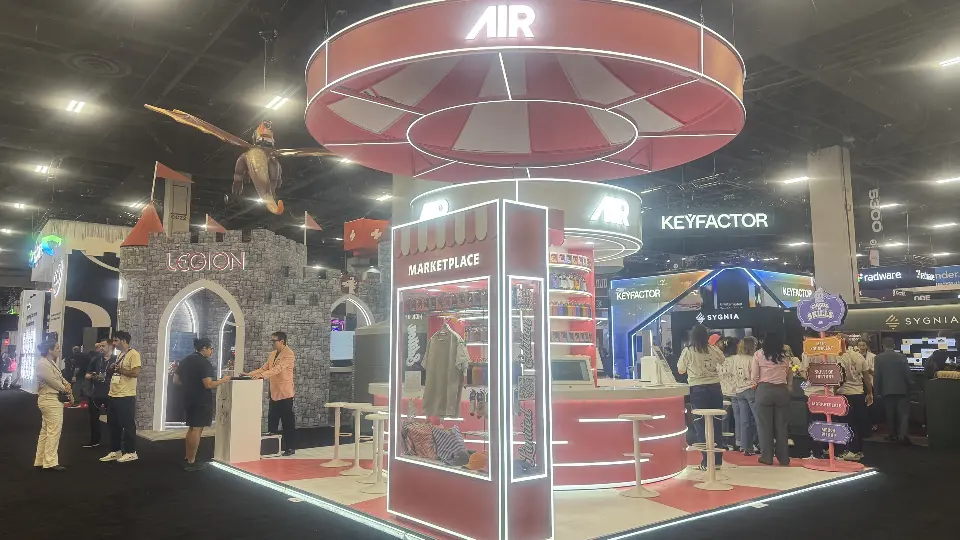 Side view of the AIR booth with a Marketplace kiosk and castle arches nearby