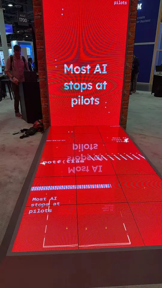 Red screen reading Most AI stops at pilots above a red-lit floor