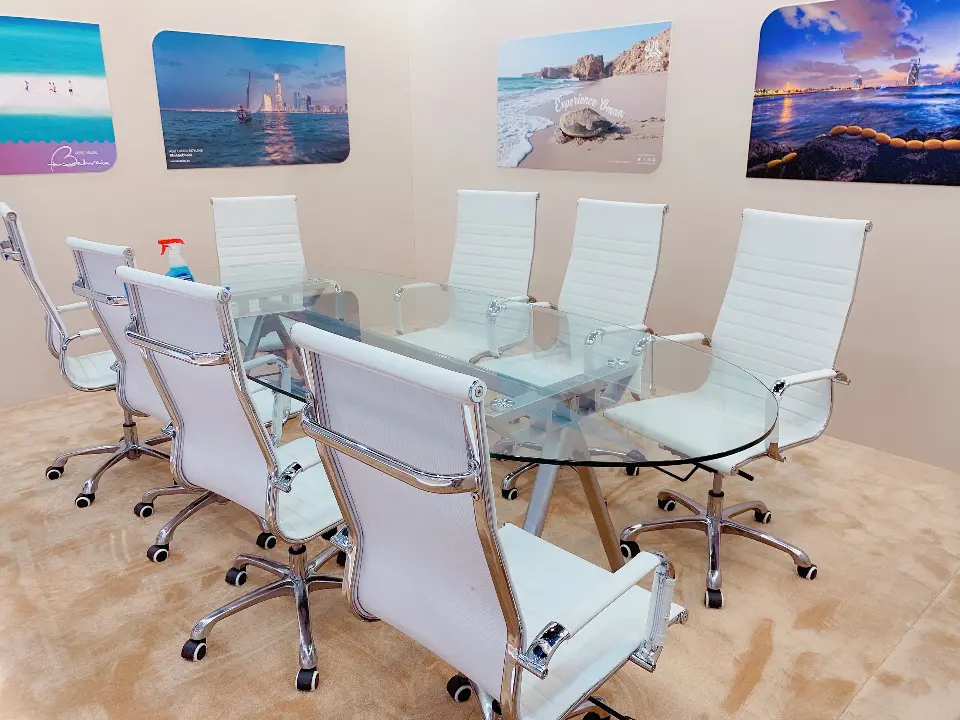 Meeting room with framed landscape photos and a glass table