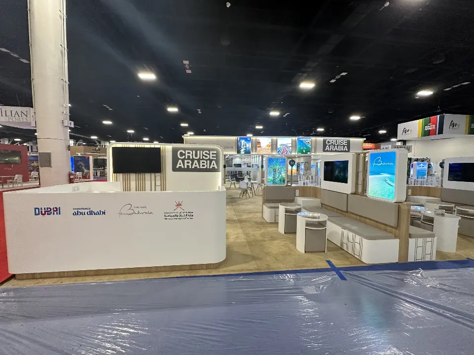 Front reception counter under the Cruise Arabia header with a wall screen