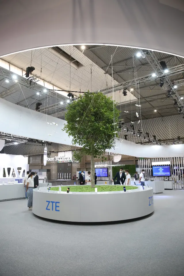 Portrait view of central tree rising from a round white counter