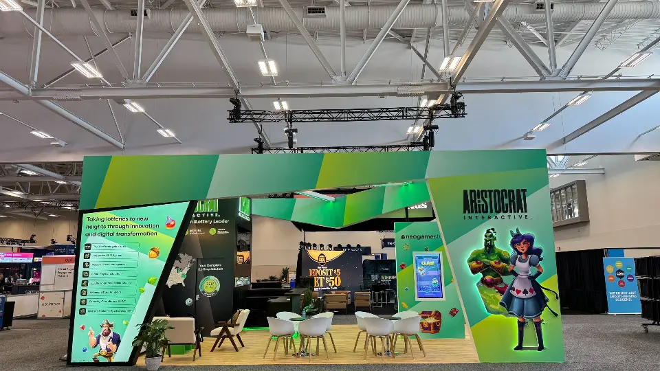 Front of the green arch frame with character graphics and white chairs on wood-look floor