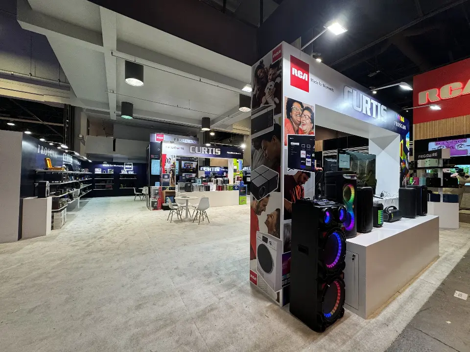 Aisle view with a tall speaker column and appliance walls behind