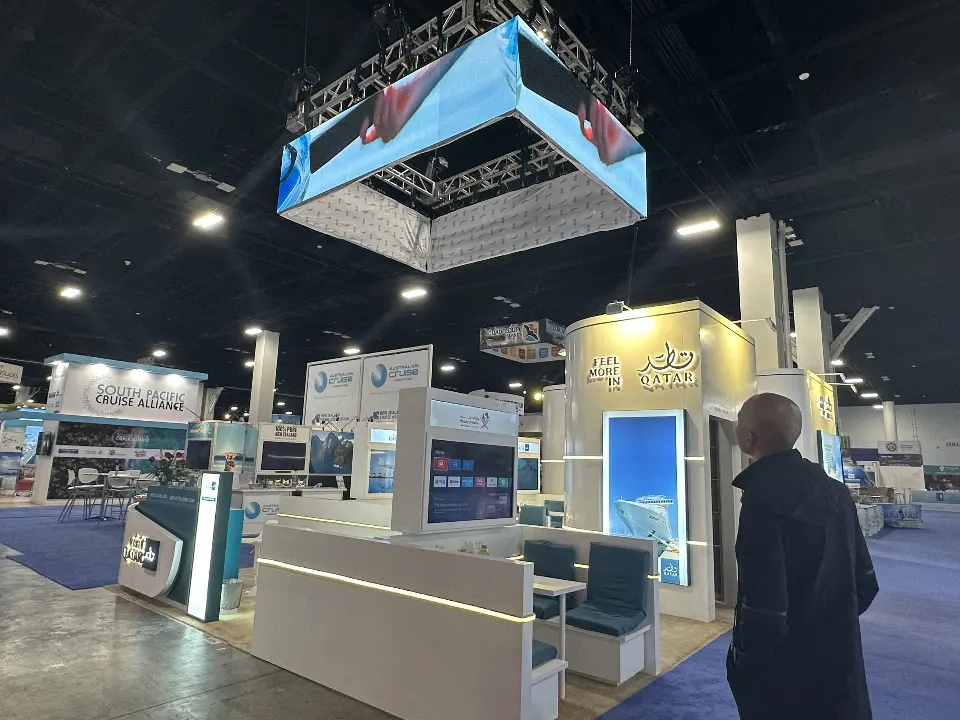 Teal booth seating with screens under the truss hanging sign