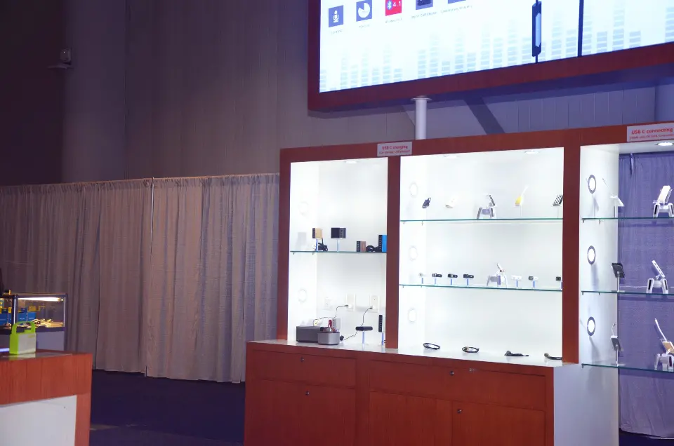 Wall shelving lined with small products under the backlit header