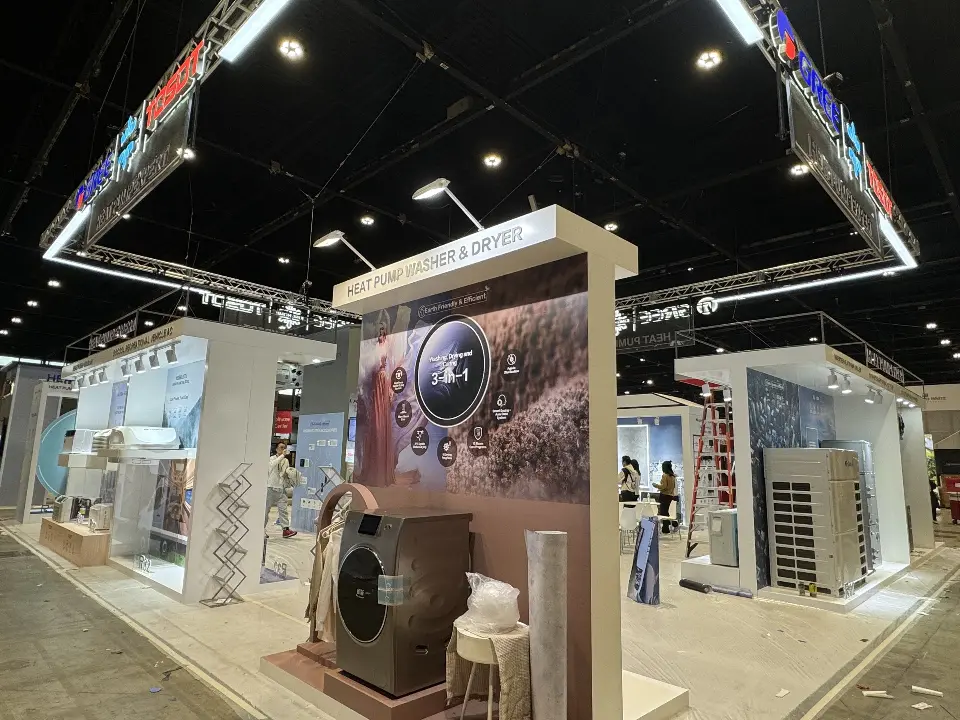 Closer view of the heat pump washer graphic panel with white stools in front